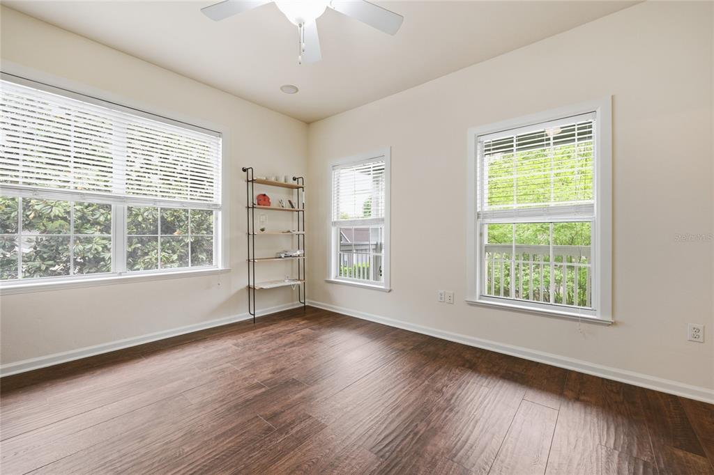 9255 Southwest 29 Avenue Gainesville, FL 32608 - Photo 55 of 79 a view of an empty room with wooden floor and a window