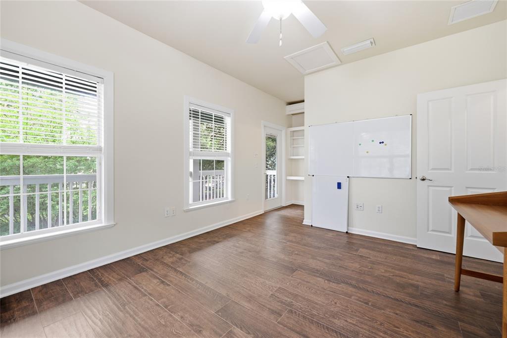 9255 Southwest 29 Avenue Gainesville, FL 32608 - Photo 58 of 79 an empty room with wooden floor and windows