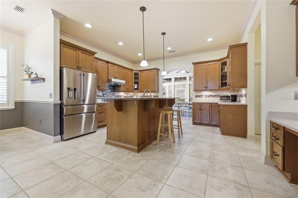 9255 Southwest 29 Avenue Gainesville, FL 32608 - Photo 9 of 79 a kitchen with stainless steel appliances granite countertop a refrigerator oven a sink dishwasher and a refrigerator
