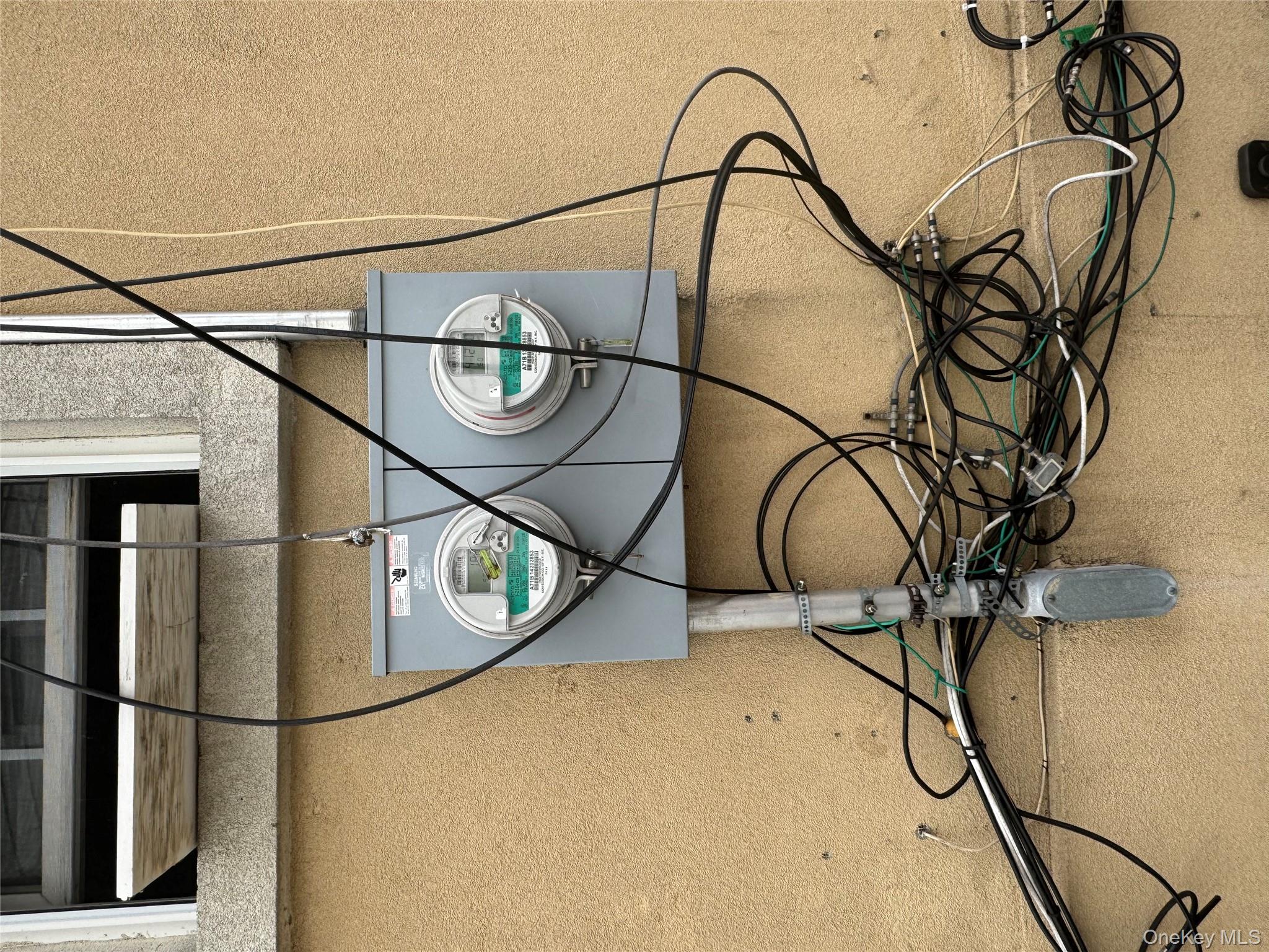 16116 Normal Road Queens, NY 11432 - Photo 4 of 5 Details featuring electric meter and stucco siding