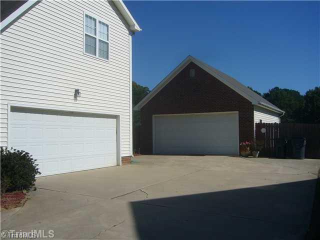 2810 Norwell Court Oak Ridge, NC 27310 - Photo 13 of 14 Parking Lot/Garage. This view of the side of the home and the detached garage show the terrific space for autos, storage, and multi-purpose activities. The detached garage includes a separate central heating and air conditioning system as well as a separate area for animals.