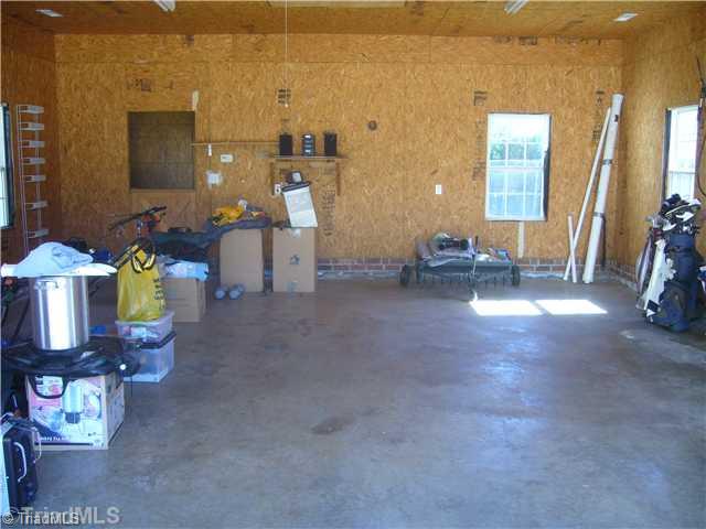 2810 Norwell Court Oak Ridge, NC 27310 - Photo 14 of 14 Parking Lot/Garage. This view of the interior of the detached garage shows how good the interior space is & the room to the left rear for animals or extra storage. This room has it s own exterior door to the outside. This area could be a workshop or even made into a bonus rm