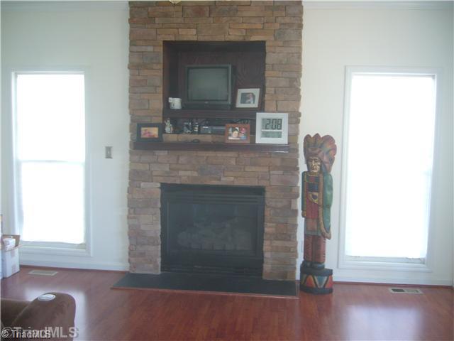 2810 Norwell Court Oak Ridge, NC 27310 - Photo 4 of 14 Den/Family/Great Room. The den is located adjacent to the living room and opens to the kitchen for a very good flow for family life and entertaining. Nice tall windows, gas log fireplace, and TV area.