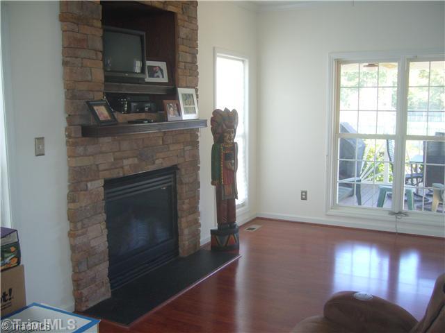 2810 Norwell Court Oak Ridge, NC 27310 - Photo 5 of 14 Den/Family/Great Room. The den shows the stone gas log fireplace, gleaming wood laminate flooring, and the great windows that lets the light in!