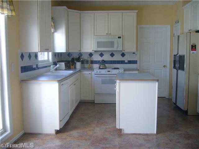 2810 Norwell Court Oak Ridge, NC 27310 - Photo 6 of 14 Kitchen. The kitchen includes a breakfast area, island, & overall good counter top space. The kitchen cabinets are 42" which allows for the extra space for storage, & matching tile backsplash & counter tops There is also a pantry & a full sized laundry room