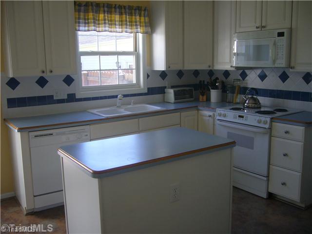 2810 Norwell Court Oak Ridge, NC 27310 - Photo 8 of 14 Kitchen. The matching kitchen appliances compliment the cabinetry and kitchen decor. Note the tilt in insulated windows that surround this energy efficient home which also includes a "Cadillac" high efficiency heating/air conditioning system w/ extra insulation.