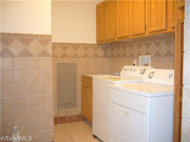 2810 Norwell Court Oak Ridge, NC 27310 - Photo 9 of 14 Laundry Room. This laundry room addition includes ceramic tile flooring and wall accents, tub cabinet sink, and plenty of cabinetry (so many that you cannot get them all in the picture).