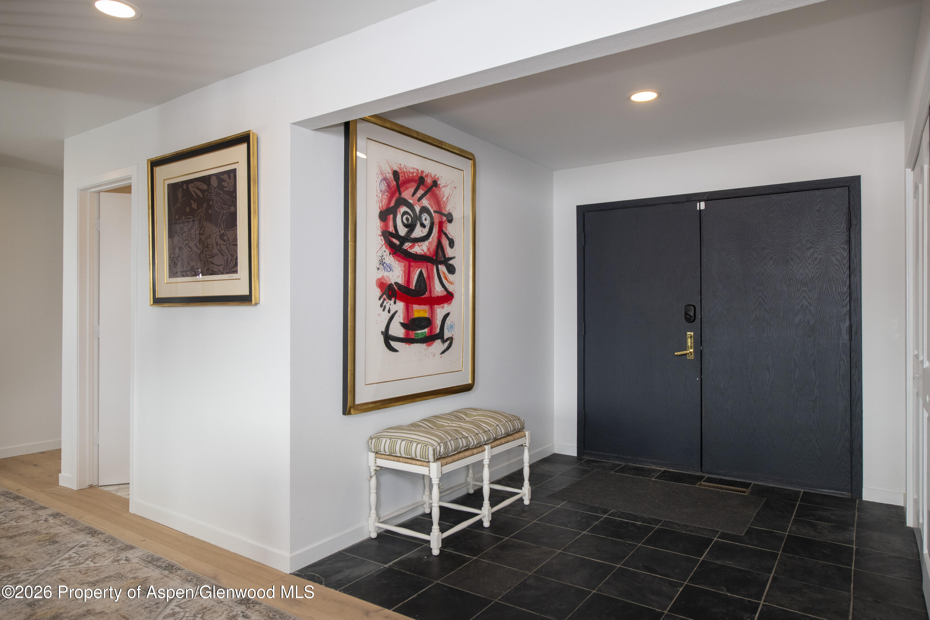 a room with a door and a painting on the wall