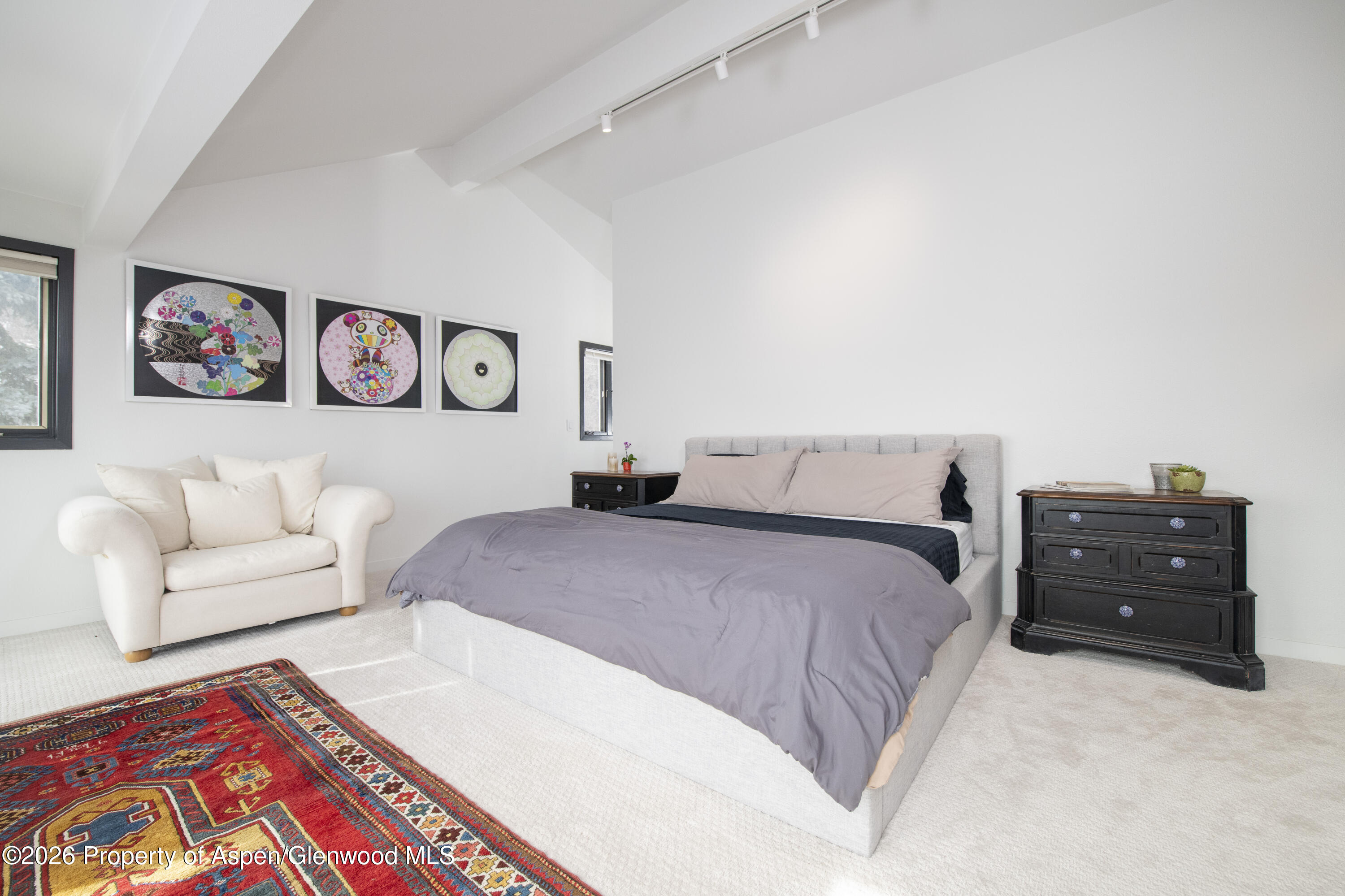 450 Solar Way Aspen, CO 81611 - Photo 15 of 51 a bedroom with a bed and a couch