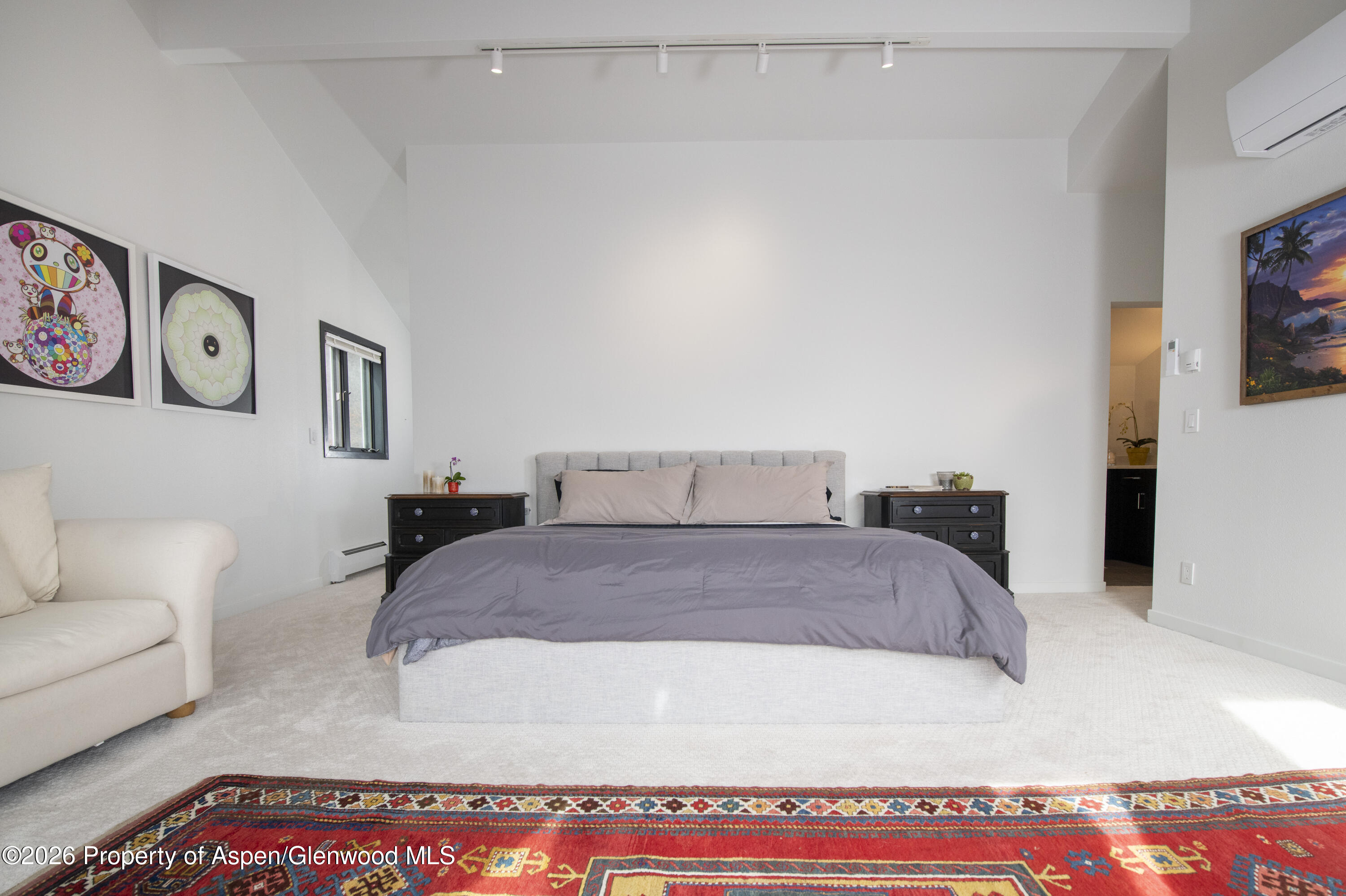 450 Solar Way Aspen, CO 81611 - Photo 16 of 51 a bedroom with a bed and a couch