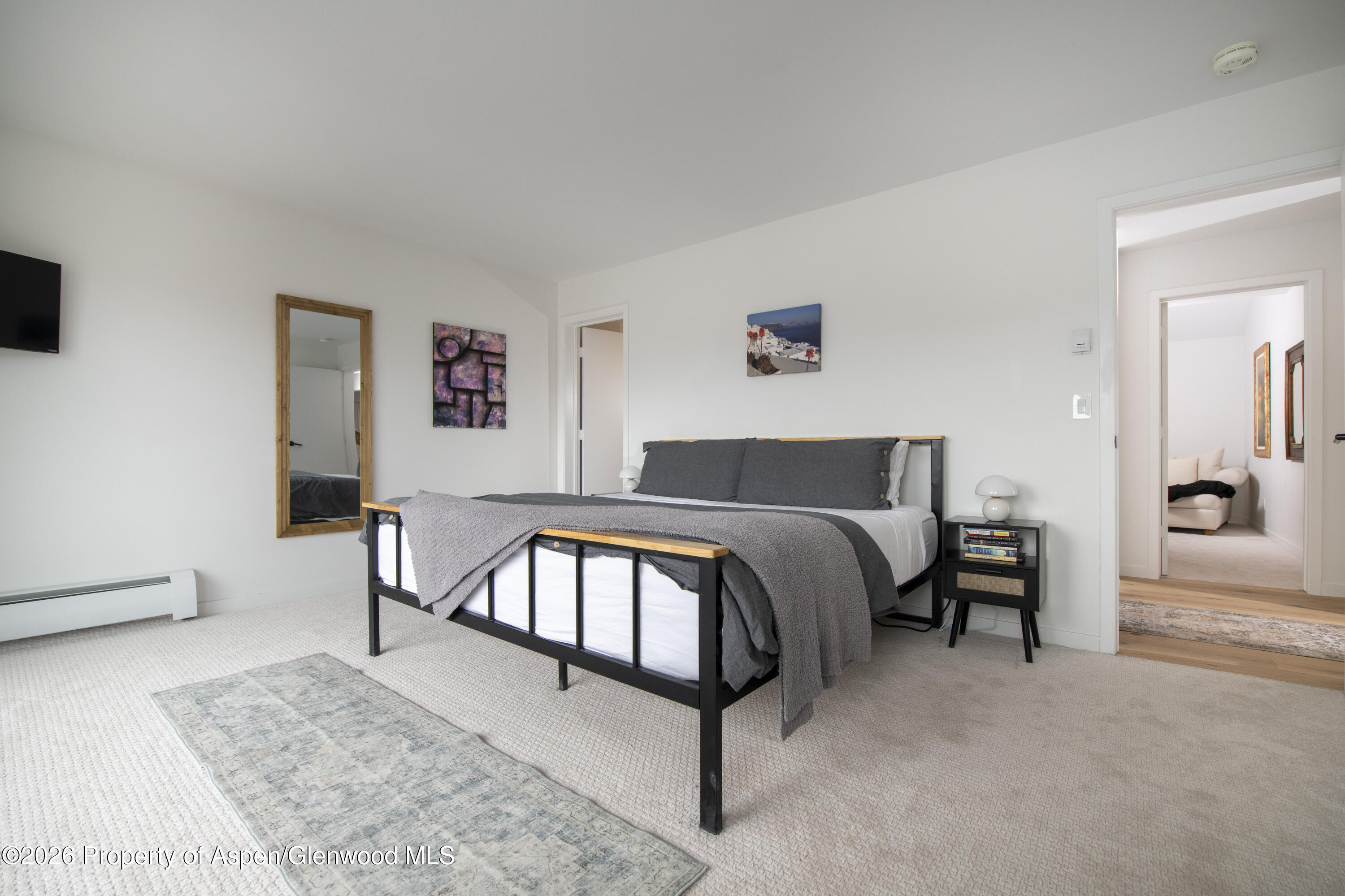 450 Solar Way Aspen, CO 81611 - Photo 27 of 51 a bedroom with a bed and a couch