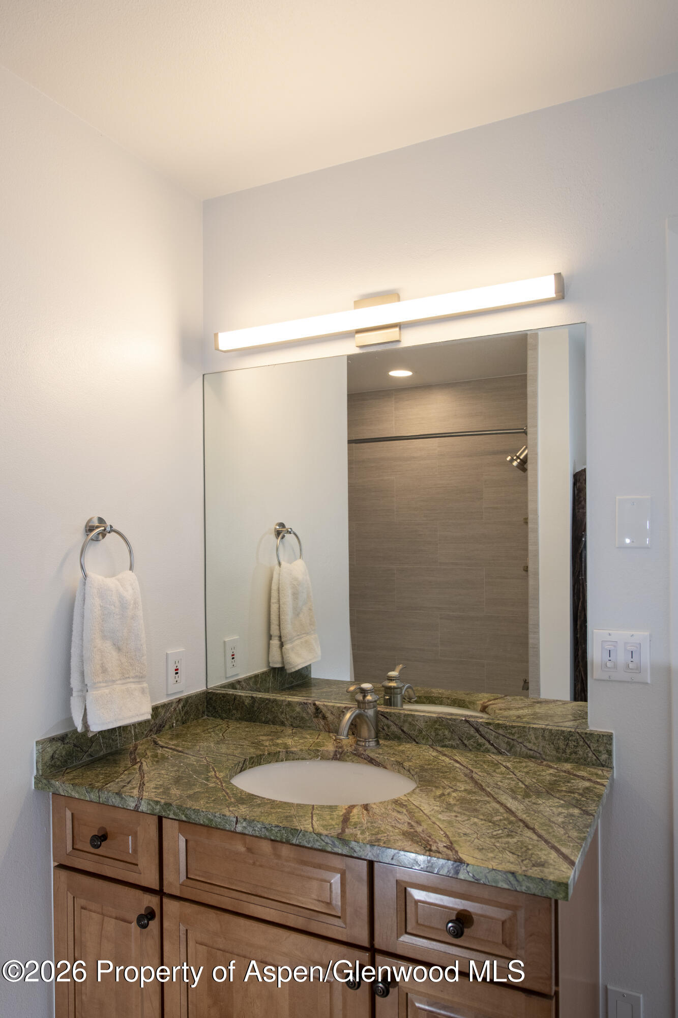 450 Solar Way Aspen, CO 81611 - Photo 30 of 51 a bathroom with a granite countertop sink and a mirror