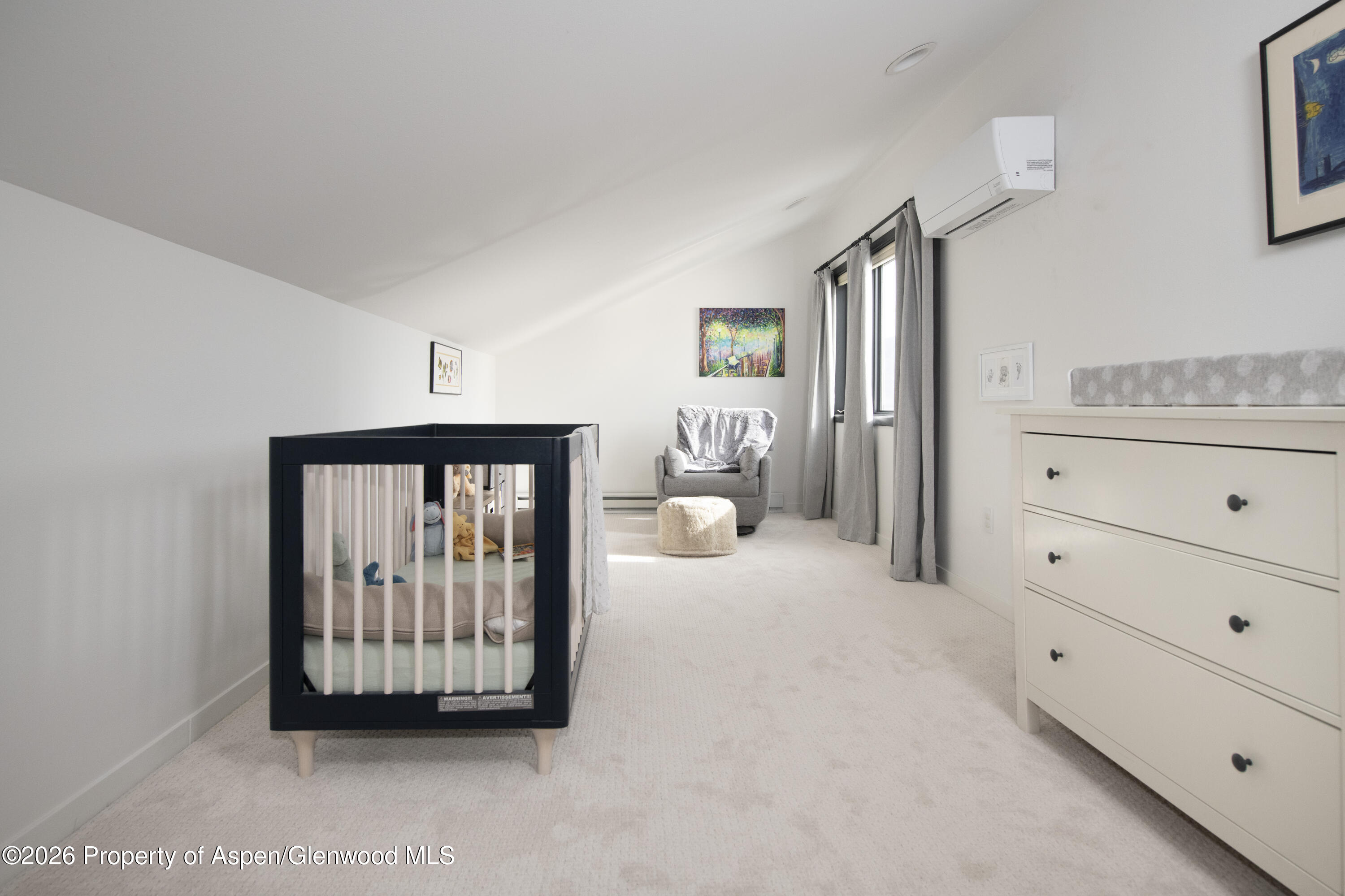 450 Solar Way Aspen, CO 81611 - Photo 33 of 51 a view of a livingroom with a baby crib and dresser