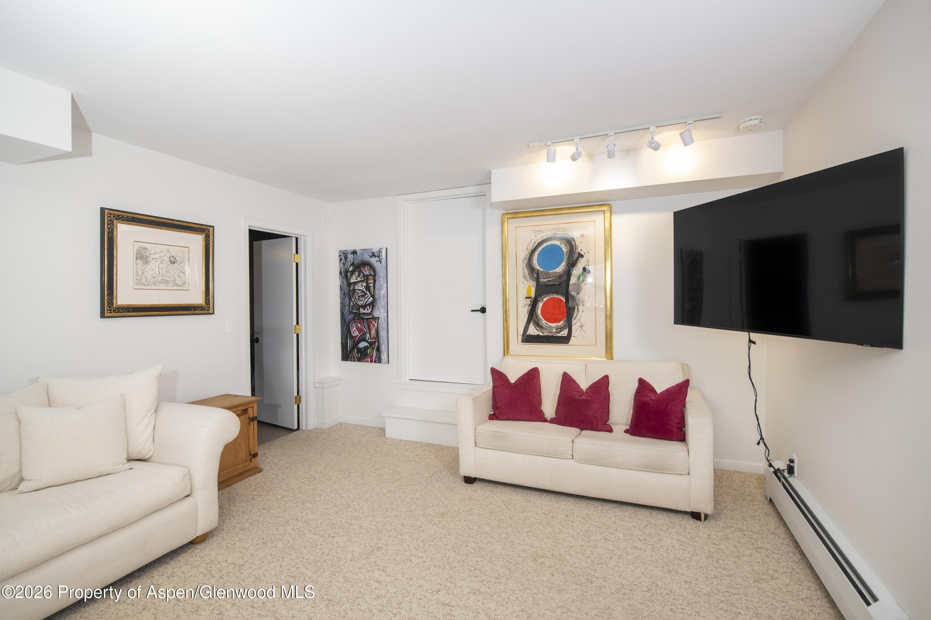 450 Solar Way Aspen, CO 81611 - Photo 37 of 51 a living room with furniture and a flat screen tv