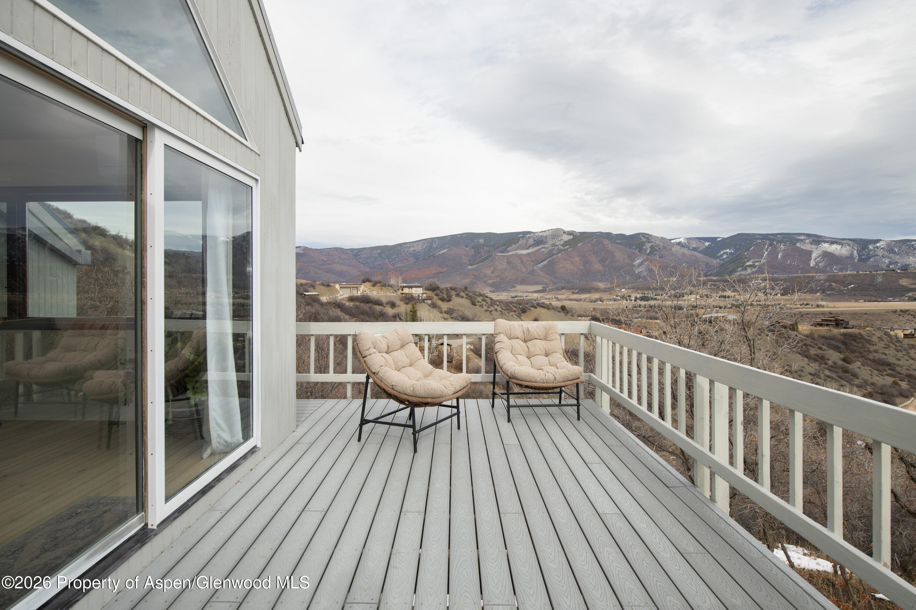 450 Solar Way Aspen, CO 81611 - Photo 41 of 51 a balcony with wooden floor and city view