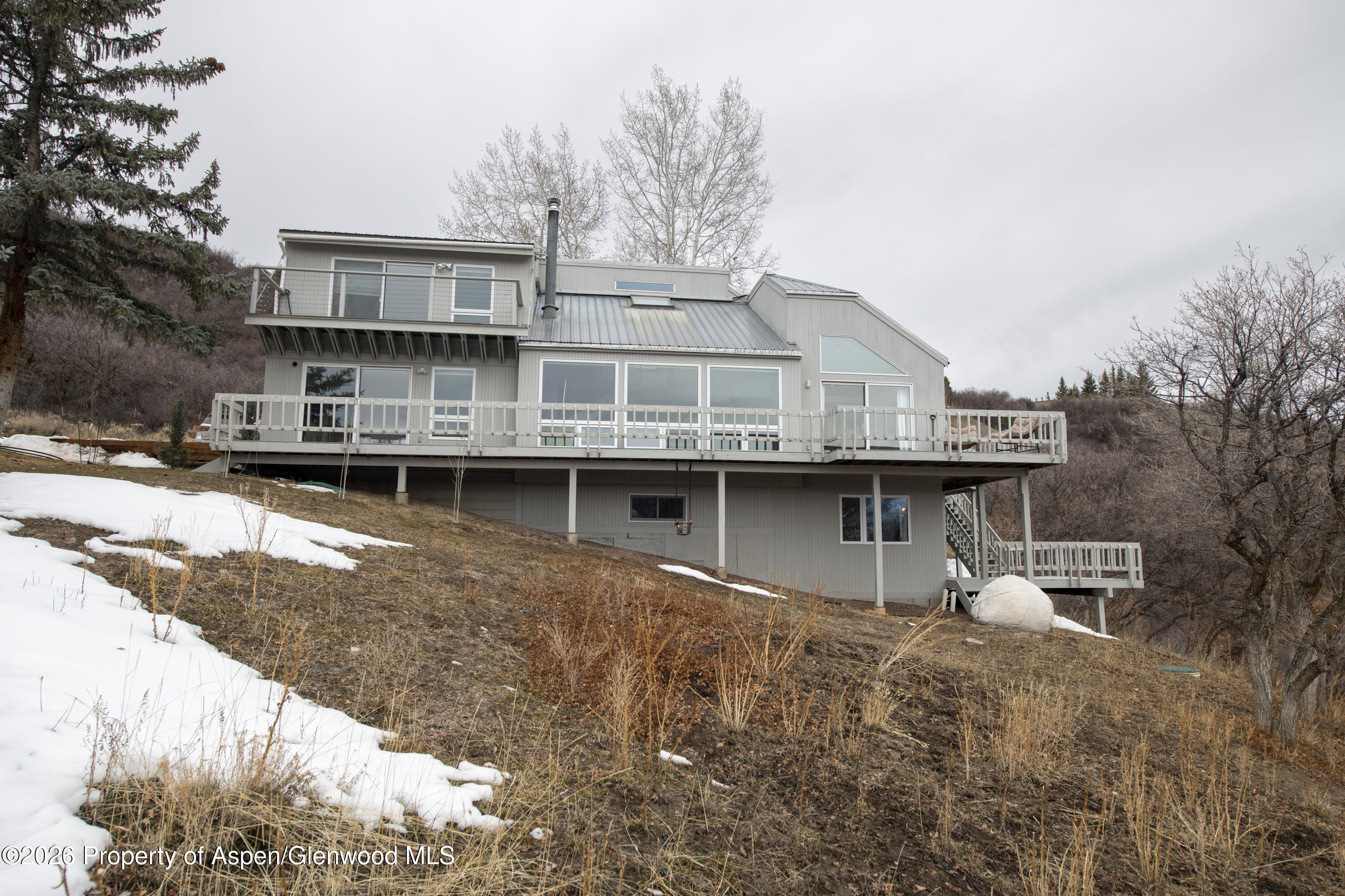 450 Solar Way Aspen, CO 81611 - Photo 44 of 51 a front view of a house with a yard and garage