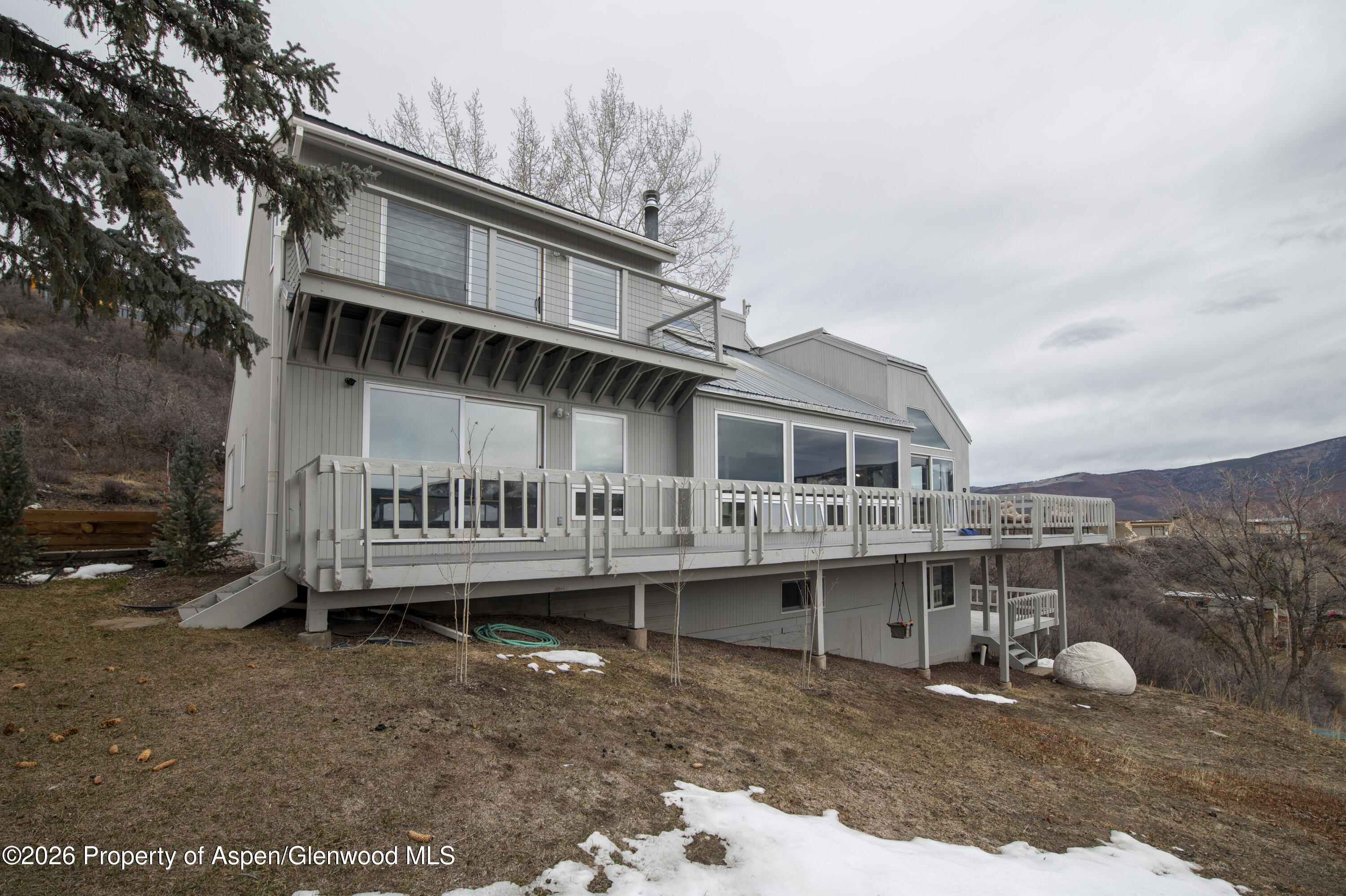 450 Solar Way Aspen, CO 81611 - Photo 45 of 51 a front view of a house with a garden and deck