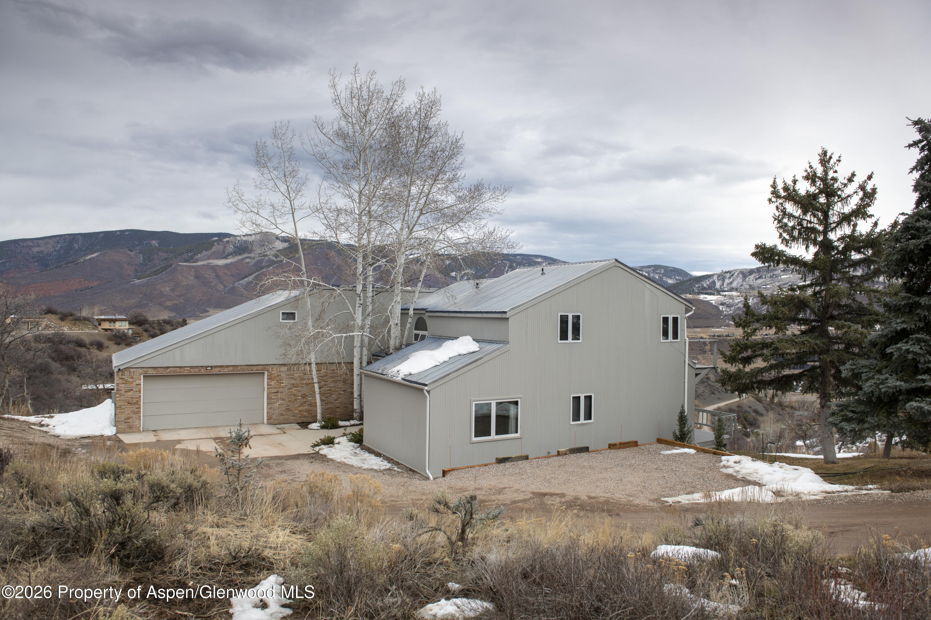 450 Solar Way Aspen, CO 81611 - Photo 46 of 51 a view of a white house with a big yard and large tree