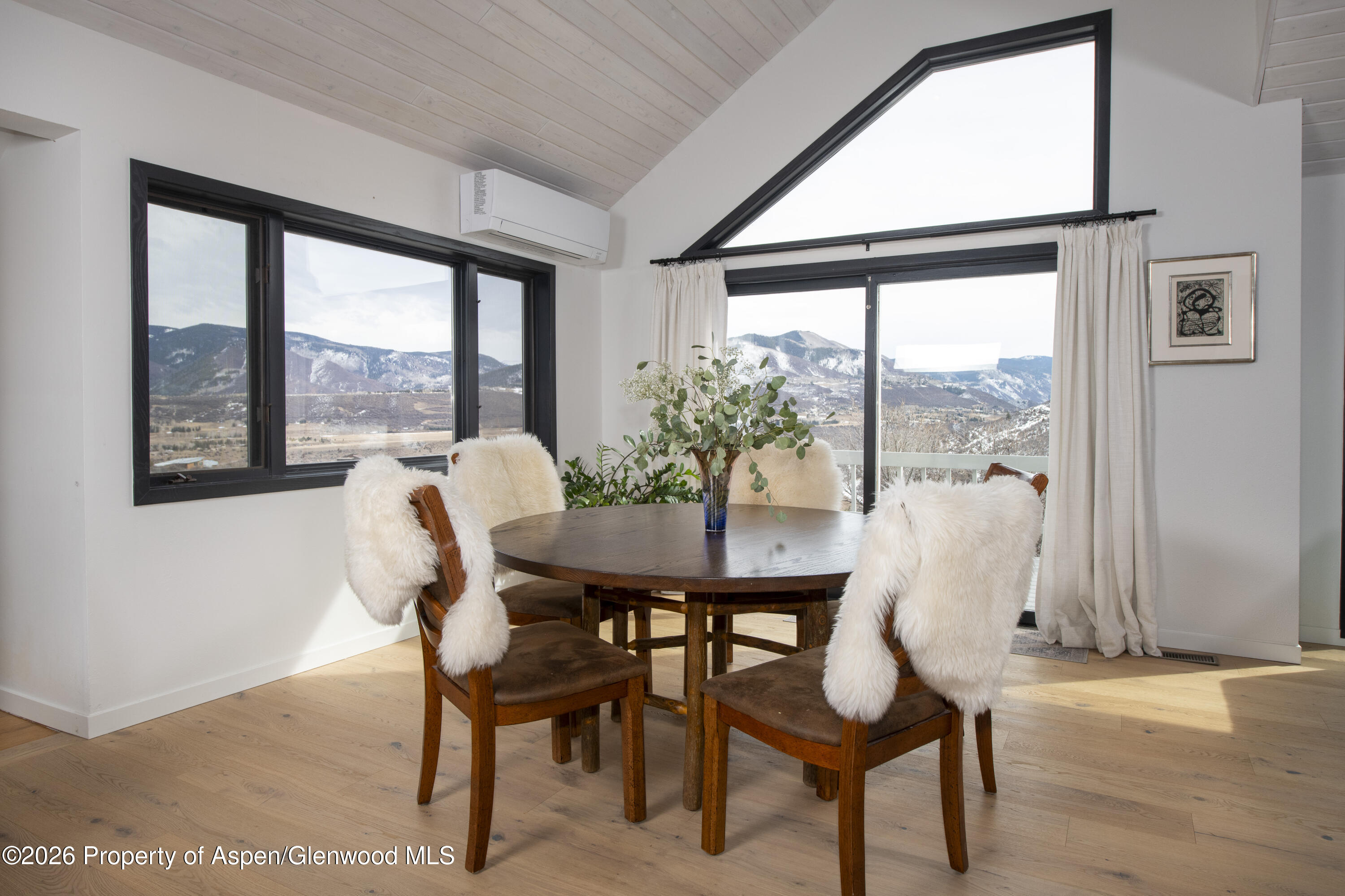 450 Solar Way Aspen, CO 81611 - Photo 9 of 51 a view of a dining room with furniture large windows and wooden floor