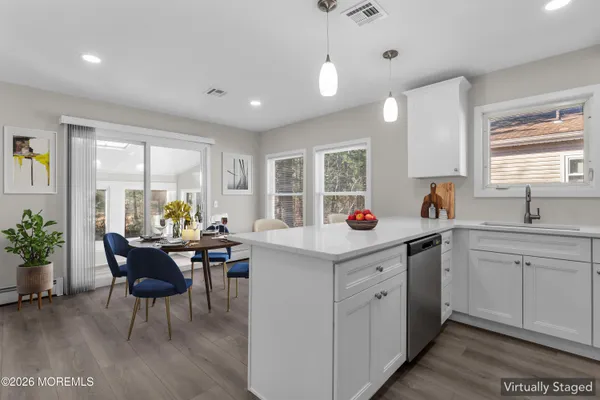 a kitchen with sink cabinets and dining table