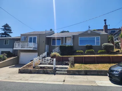 a front view of a house with sitting area