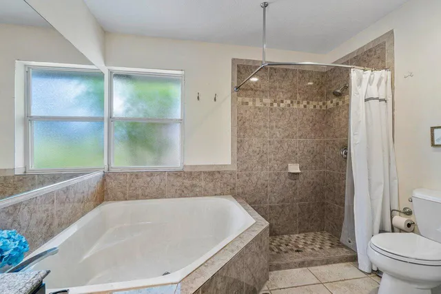 a bathroom with a granite countertop toilet sink and shower