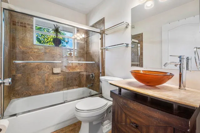 a living room with furniture ceiling fan and a rug