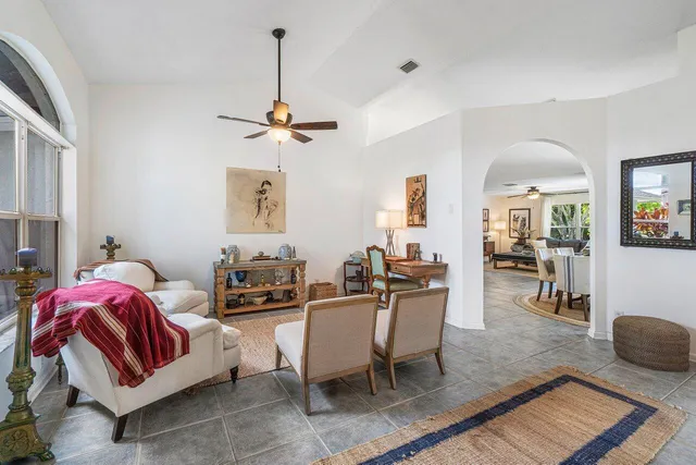 a living room with furniture flat screen tv and a window
