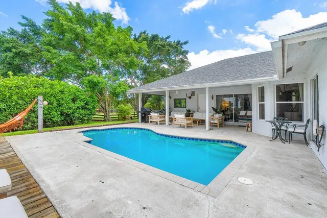 a view of a swimming pool with a yard