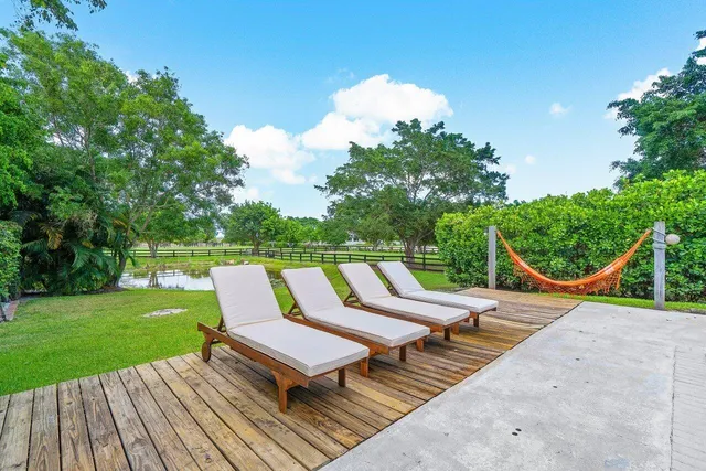 a view of a house with swimming pool and sitting area