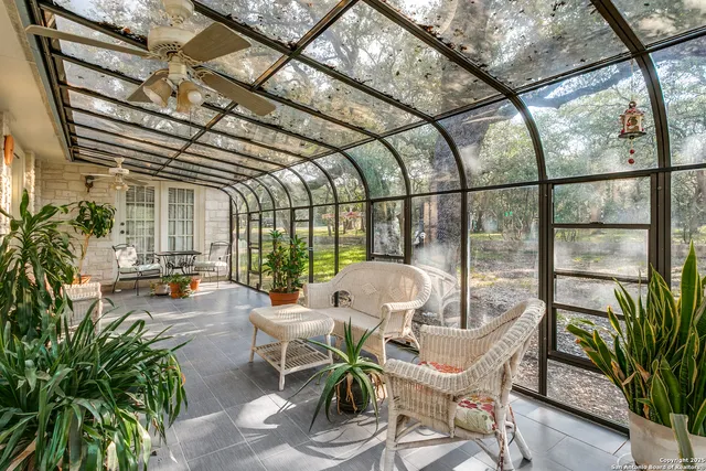 a view of a porch with chairs and potted plants