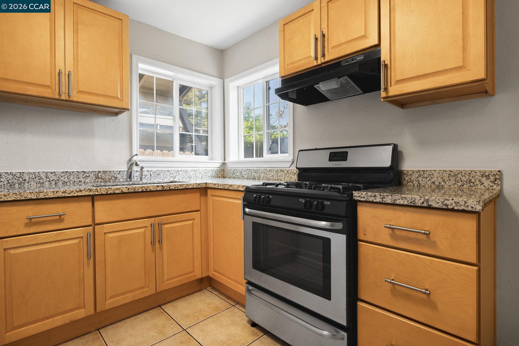 4820 Blum Road Martinez, CA 94553 - Photo 28 of 46 a kitchen with granite countertop cabinets stainless steel appliances and a sink