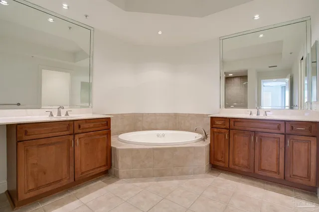 a bathroom with a double vanity sink mirror and toilet