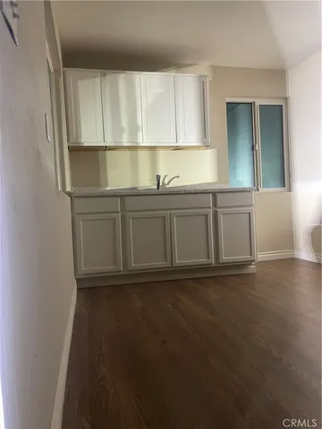 a kitchen with granite countertop a sink and a stove