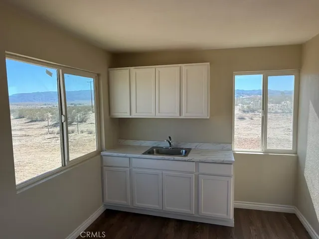 a kitchen with a sink a window and cabinets