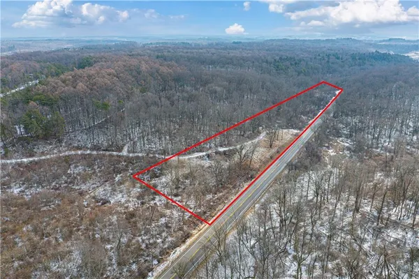 a view of a yard with wooden fence