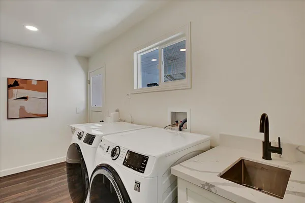 a kitchen with stainless steel appliances granite countertop white cabinets and a sink