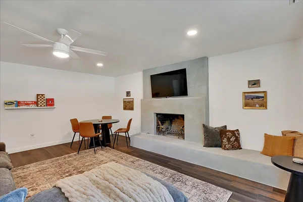 a living room with furniture and a wooden floor