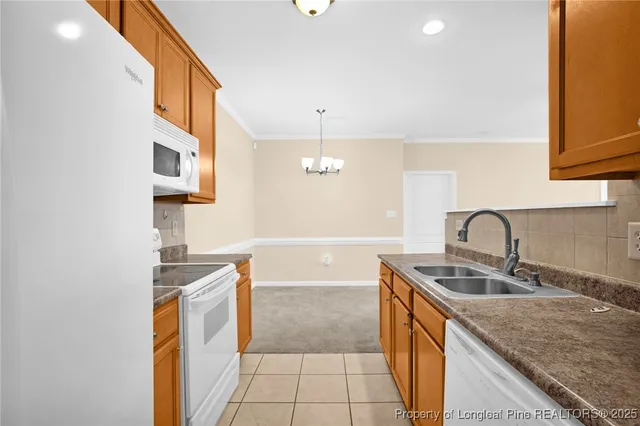 a kitchen with stainless steel appliances granite countertop a sink and a stove