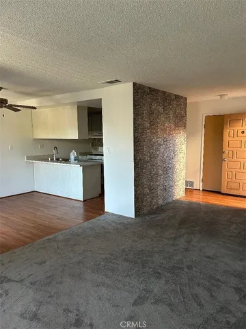 a view of a kitchen with a stove cabinets and a wooden floor