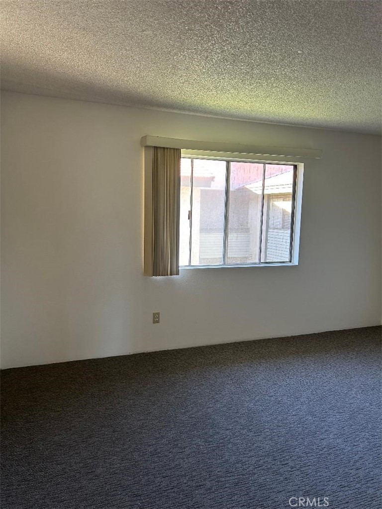 2255 Cahuilla Street, Unit 90 Colton, CA 92324 - Photo 8 of 12 an empty room with a window