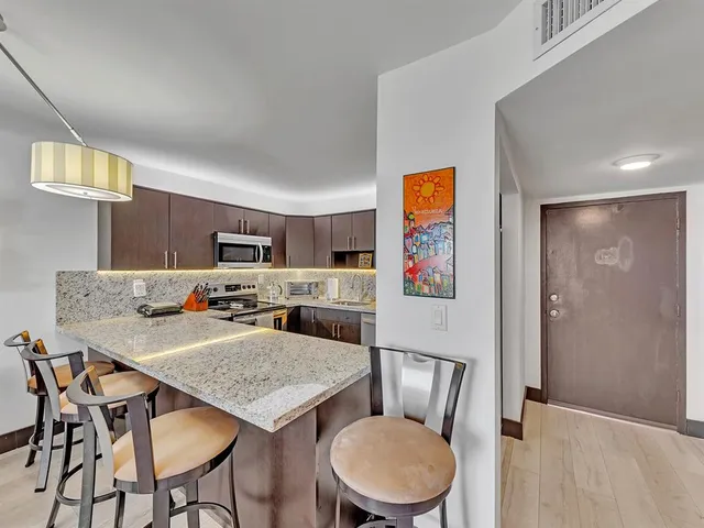 a living room with furniture and painting on the wall