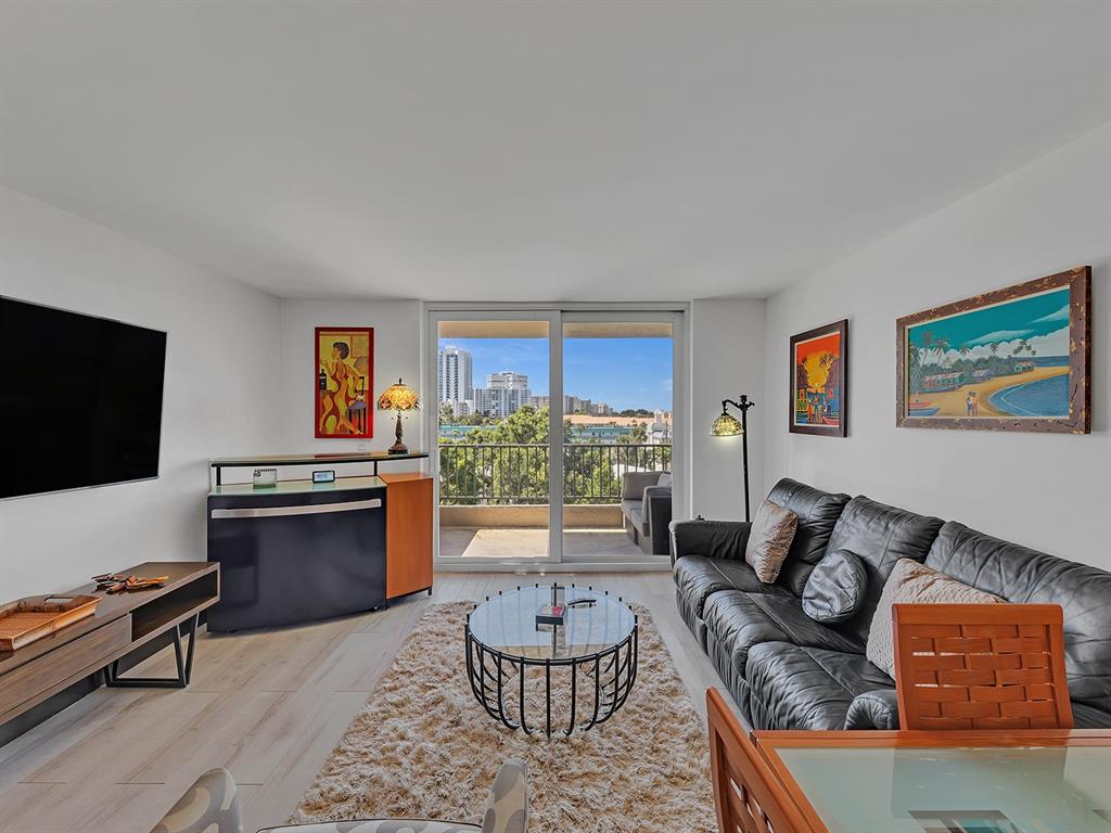 1421 South Ocean Boulevard, Unit 506 Pompano Beach, FL 33062 - Photo 14 of 36 a living room with furniture and a flat screen tv