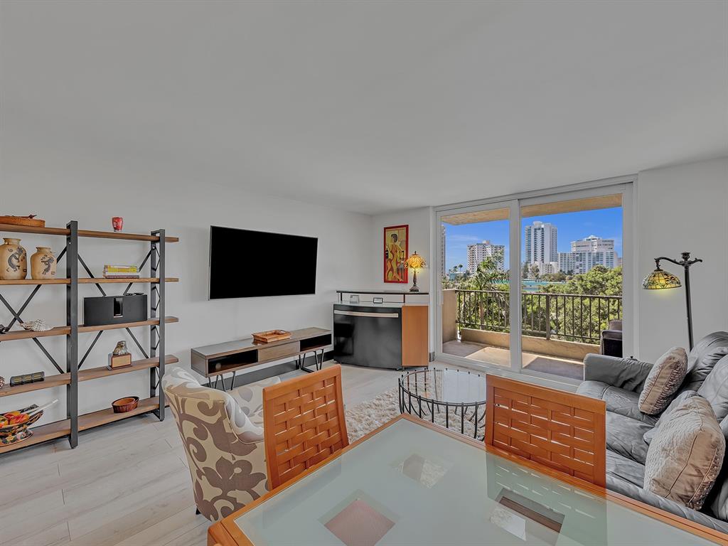 1421 South Ocean Boulevard, Unit 506 Pompano Beach, FL 33062 - Photo 15 of 36 a living room with furniture and a flat screen tv