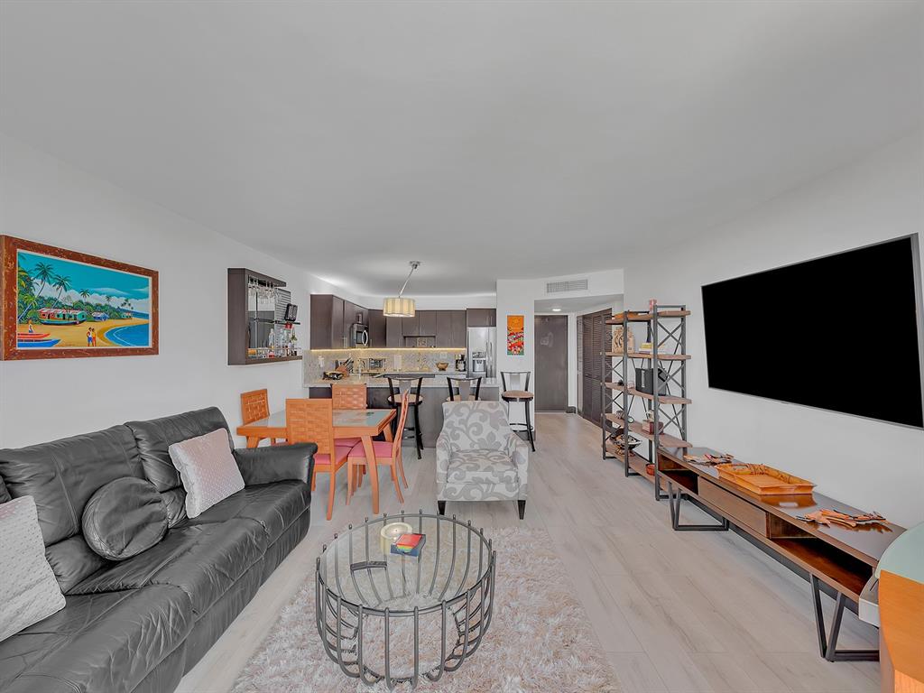 1421 South Ocean Boulevard, Unit 506 Pompano Beach, FL 33062 - Photo 16 of 36 a living room with furniture and a flat screen tv