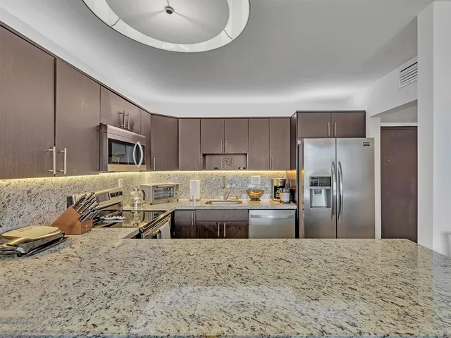 a living room with chairs and entryway