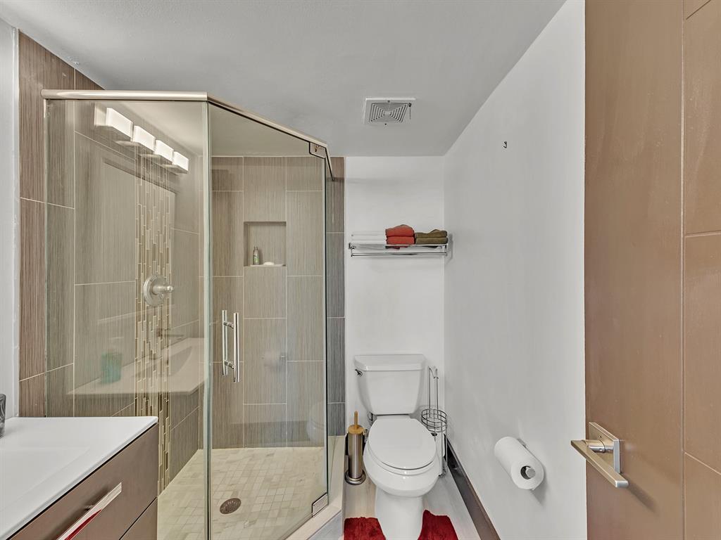 1421 South Ocean Boulevard, Unit 506 Pompano Beach, FL 33062 - Photo 20 of 36 a bathroom with a shower and a toilet