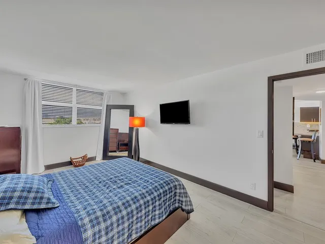 a bedroom with a bed and a flat screen tv