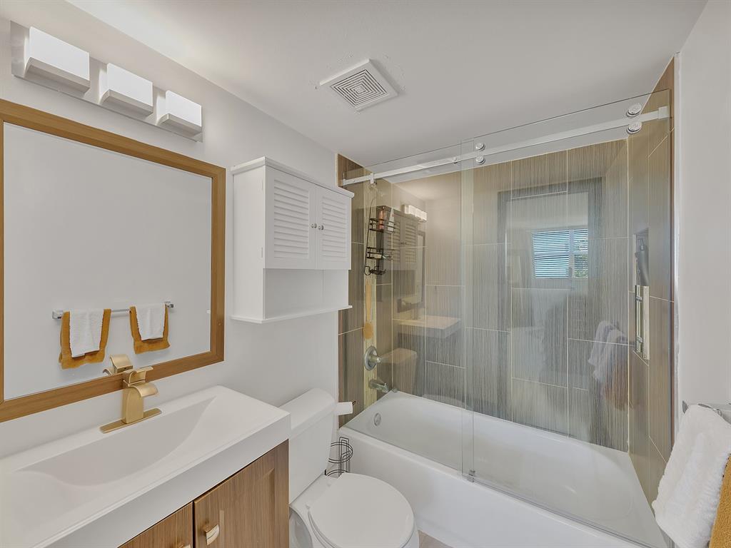 1421 South Ocean Boulevard, Unit 506 Pompano Beach, FL 33062 - Photo 27 of 36 a bathroom with a sink toilet and shower