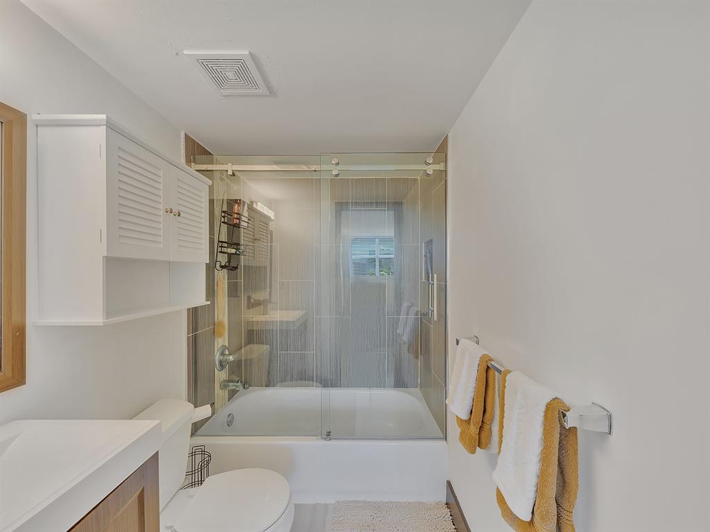 1421 South Ocean Boulevard, Unit 506 Pompano Beach, FL 33062 - Photo 28 of 36 a bathroom with a sink toilet and shower